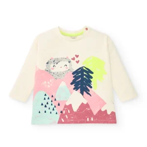 Camiseta de manga larga color crema con estampado de montaña y personaje invernal para niña de la colección Freezy